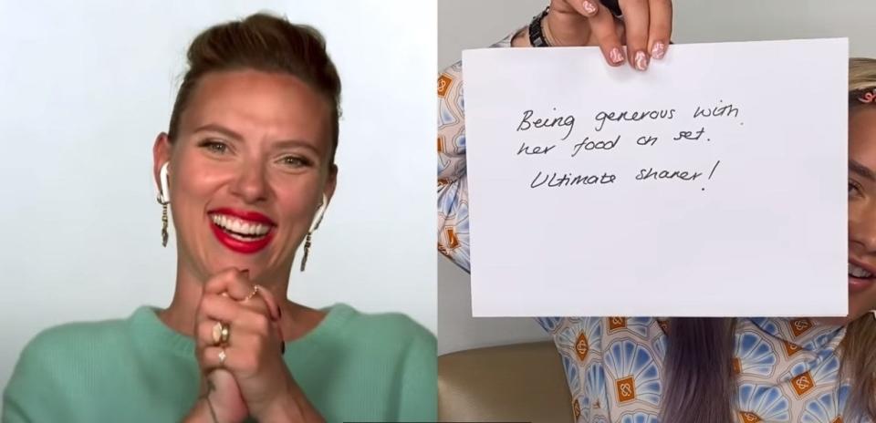 Scarlett laughs while Florence holds up a sheet of paper with something written on it.