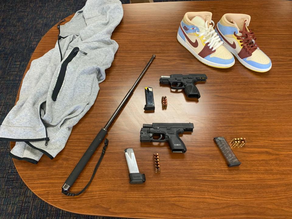 Deputies seized stolen clothing, two loaded firearms, a loaded gun magazine and an expandable police baton during a search warrant in Palmdale on Wednesday.