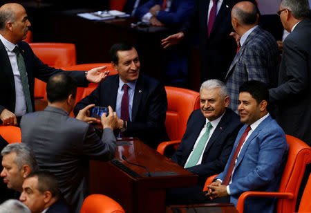 Binali Yildirim (2nd R), the likely new leader of Turkey's ruling AK Party, poses with his party lawmakers during a debate at the Turkish parliament in Ankara, Turkey, May 20, 2016. REUTERS/Umit Bektas