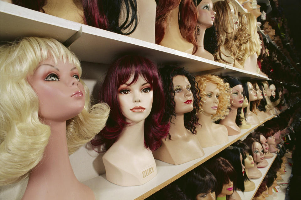 Rows of mannequin heads with wigs