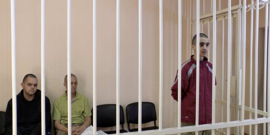 from left: Britons Aiden Aslin, Sean Pinner and Moroccan Brahim Saadun in the courtroom in occupied Donetsk