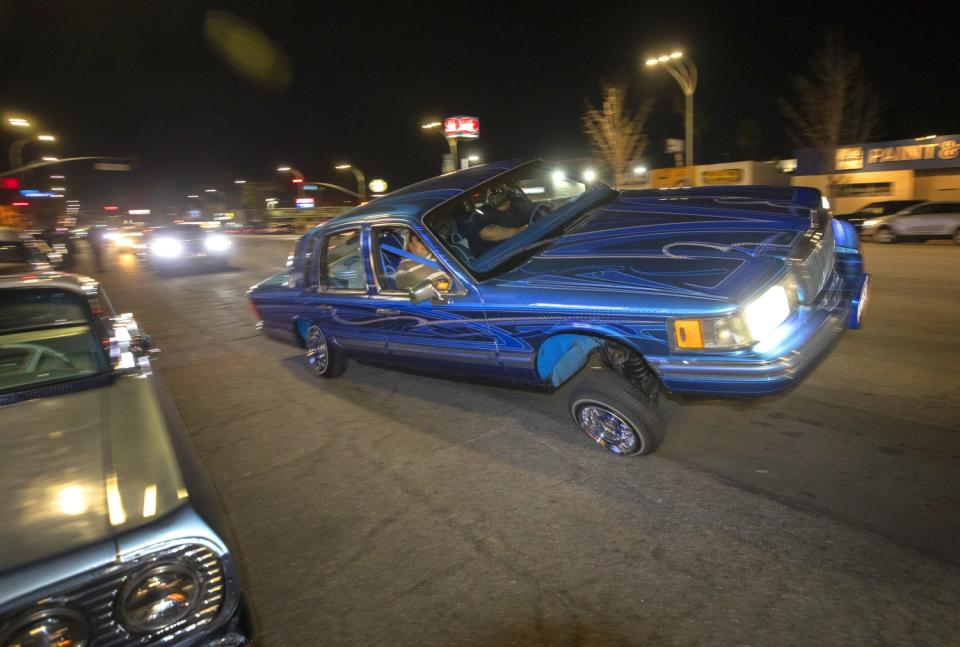 A bright blue lowrider cruises Van Nuys Boulevard