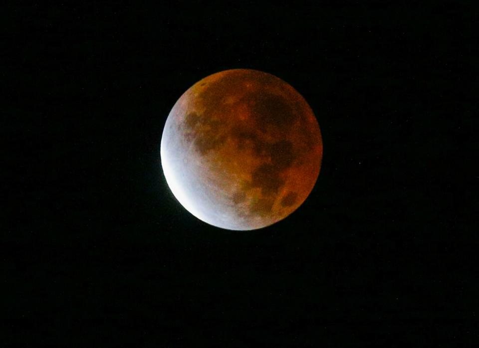 A partial lunar eclipse occurred in November 2021, with the red hue coming from refracted sunlight. A "super flower blood moon" lunar eclipse will take place Sunday night.