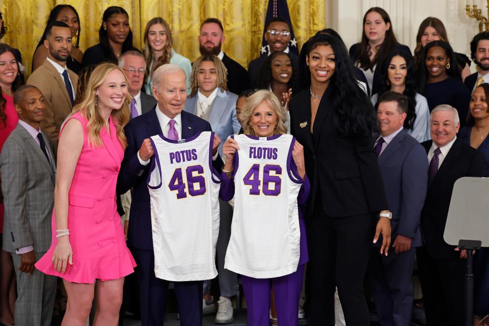 President Joe Biden and first lady Jill Biden pose for photographs with LSU players Emily Ward, left, and Angel Reese, right, during a White House ceremony honoring the Tigers winning the NCAA women's basketball tournament.