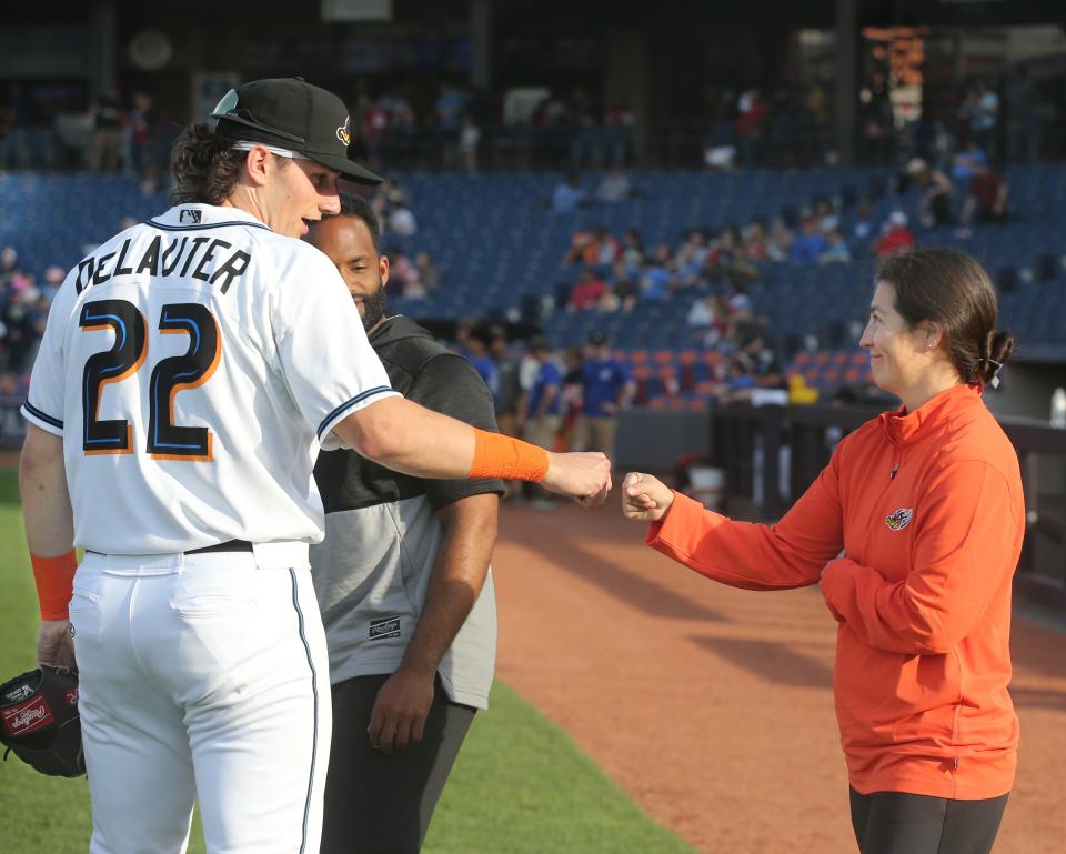 Ducks assistant athletic trainer Karina Gonzalez gets a first bump from Chase DeLauter before the game against the Erie SeaWolves earlier this week.