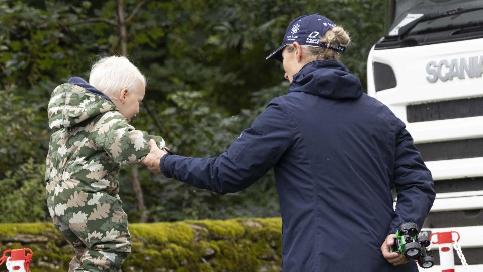 Lucas Tindall bouncing on a trampoline while holding Zara Tindall's hand