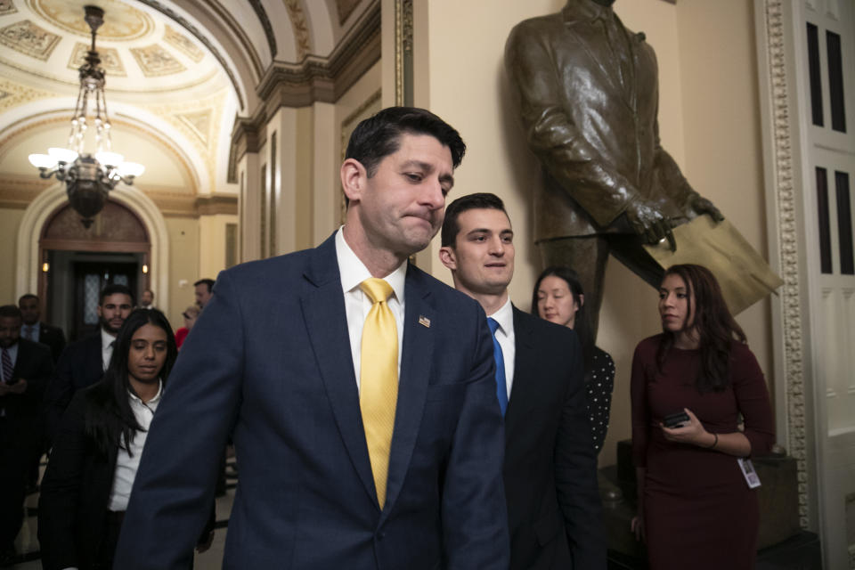 House Speaker Paul Ryan leaves the chamber as a revised spending bill is introduced that includes $5 billion demanded by President Donald Trump for a wall along the U.S.-Mexico border, as Congress tries to avert a partial shutdown, in Washington, Thursday, Dec. 20, 2018. (AP Photo/J. Scott Applewhite)