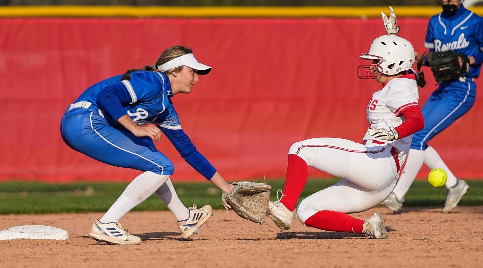 Fishers Tigers Hailey Trueblood (14) slides into second base against Hamilton Southeastern Royals Tessa Sexauer (7) on Tuesday, April 25, 2023 at Fishers High School in Fishers. The Fishers Tigers defeated the Hamilton Southeastern Royals, 1-0. 