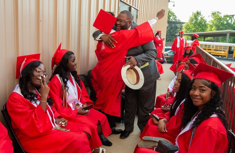 May 17, 2022; Tuscaloosa, AL, USA; Central High School students in the Class of 2022 prepare for their graduation at the Tuscaloosa Amphitheater Tuesday. Tuscaloosa city councilman Matthew Wilson hugs one of the graduates backstage before the ceremony. Gary Cosby Jr.-The Tuscaloosa News