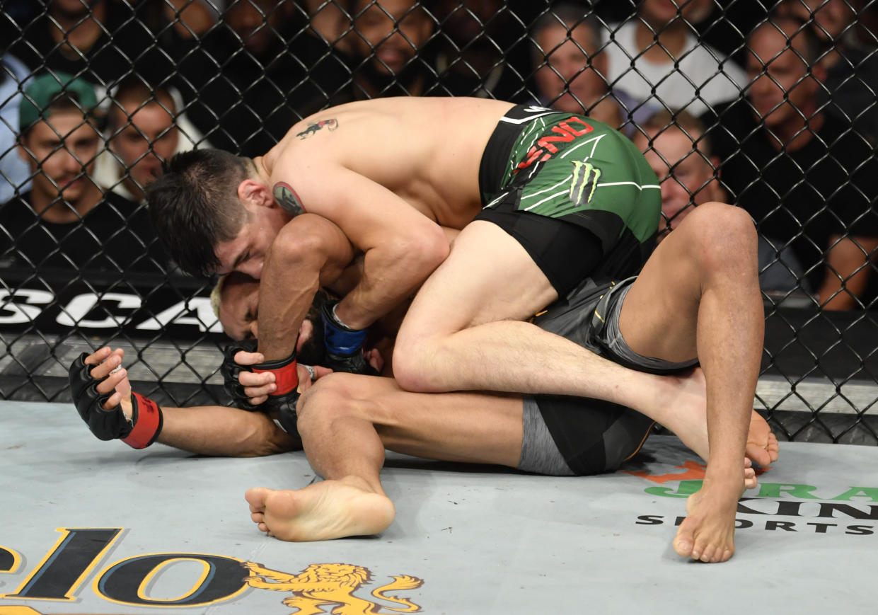 GLENDALE, ARIZONA - JUNE 12: (R-L) Brandon Moreno of Mexico grapples with Deiveson Figueiredo of Brazil in their UFC flyweight championship fight during the UFC 263 event at Gila River Arena on June 12, 2021 in Glendale, Arizona. (Photo by Jeff Bottari/Zuffa LLC)