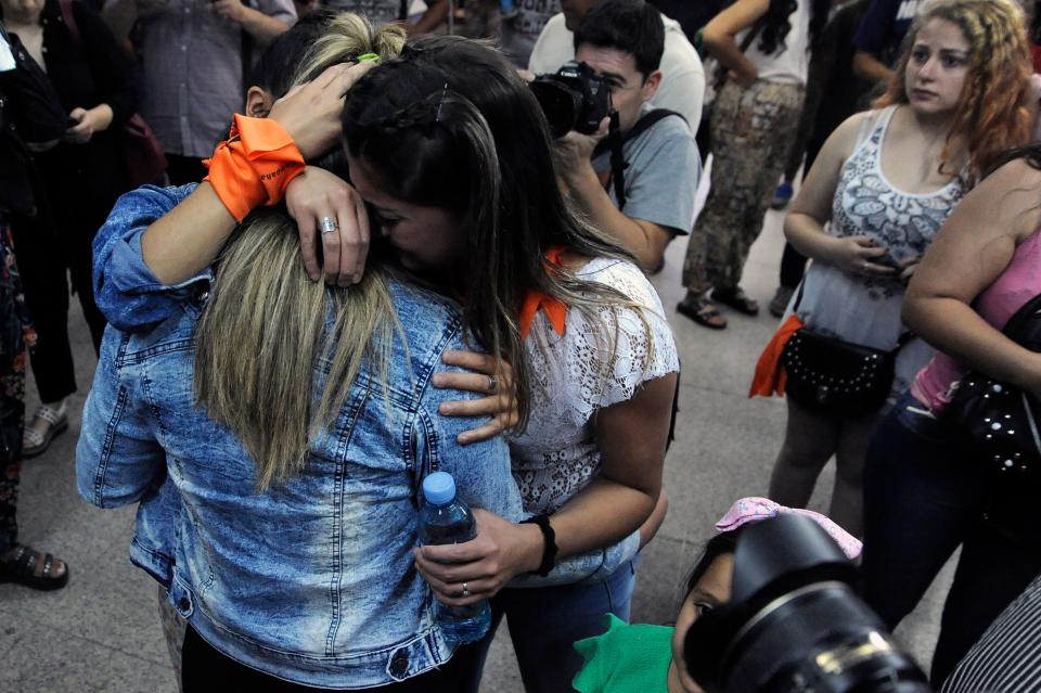 The victims and family members embracing outside the court house in Argentina, after hearing the verdict.