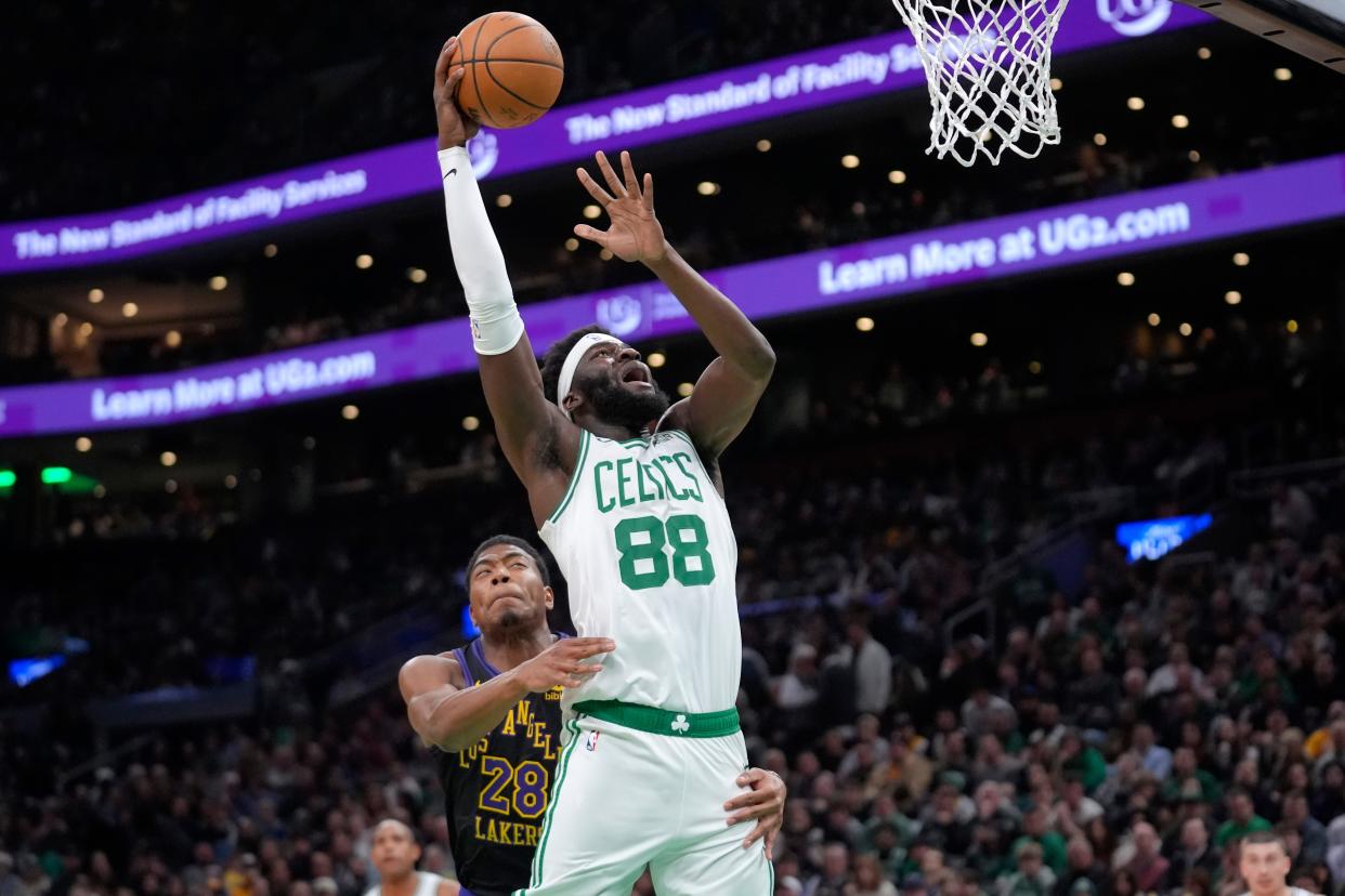 Boston Celtics center Neemias Queta (88) takes a shot at the basket as Los Angeles Lakers forward Rui Hachimura (28) defends in the first half of an NBA basketball game, Thursday, Feb. 1, 2024, in Boston. (AP Photo/Steven Senne)
