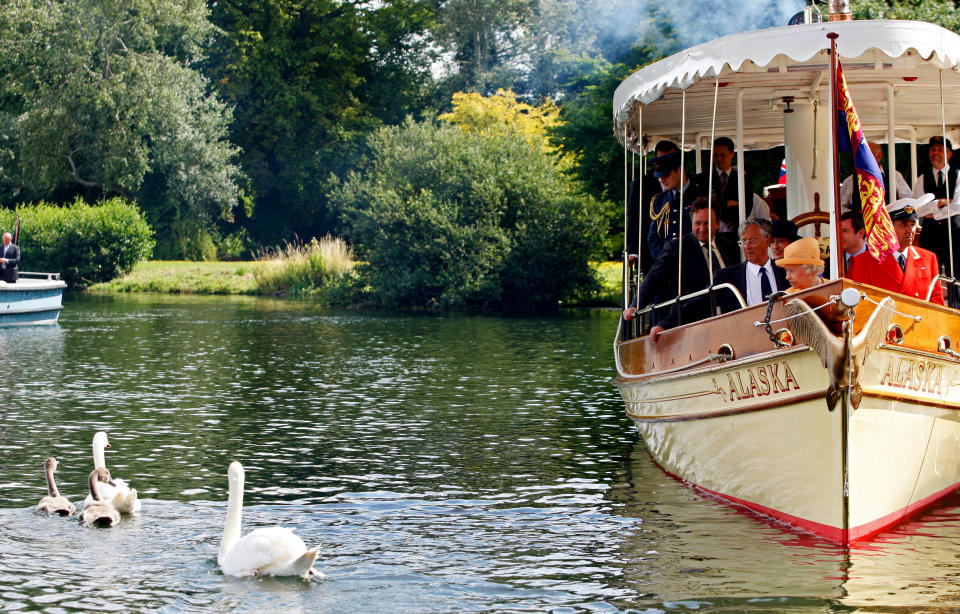 WINDSOR, UNITED KINGDOM - JULY 20:  Queen Elizabeth II (front) watches swans swim away from the steam launch 'Alaska' during a swan upping census on the River Thames on July 20, 2009 near Windsor, England. During the ancient annual ceremony the Swan Marker leads a team of Swan Uppers on a five-day journey along the River Thames from Sunbury-on-Thames through Windsor to Abingdon counting, marking and checking the health of all unmarked swans.  (Photo by Sang Tan - WPA Pool/Getty Images)