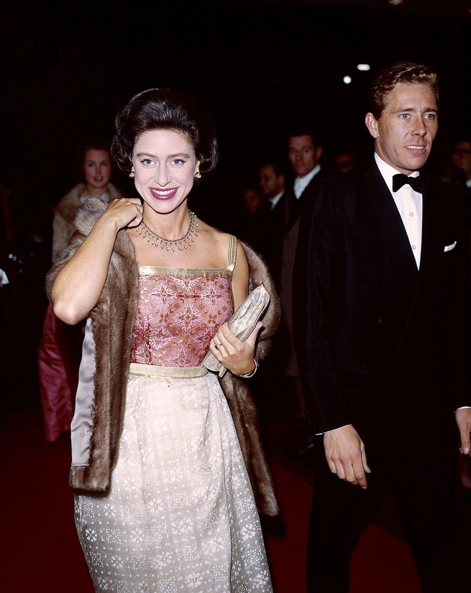 <p>Princess Margaret and Lord Snowdon arrive at the Hilton Hotel in London. The Princess is wearing a cerise and gold gown and a brown mink stole.</p>