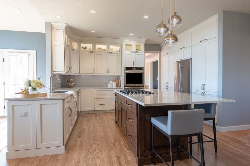 Globe pendant lamps over wooden kitchen island.