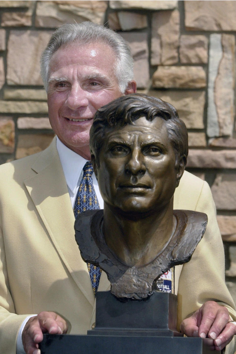 FILE - In this Aug. 4, 2001, file photo, former Miami Dolphins great Nick Buoniconti holds his bronze bust after enshrinement into the Pro Football Hall of Fame in Canton, Ohio. Nick Buoniconti, an undersized overachiever who helped lead the Miami Dolphins to the NFL's only perfect season, has died at the age of 78. Bruce Bobbins, a spokesman for the Buoniconti family, said he died Tuesday, July 30, 2019, in Bridgehampton, N.Y. (AP Photo/Mark Duncan)