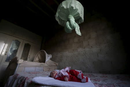 Sophia, 18 days old, who is Ianka Mikaelle Barbosa's second child and was born with microcephaly, lies on a bed inside her house in Campina Grande, Brazil February 17, 2016. REUTERS/Ricardo Moraes