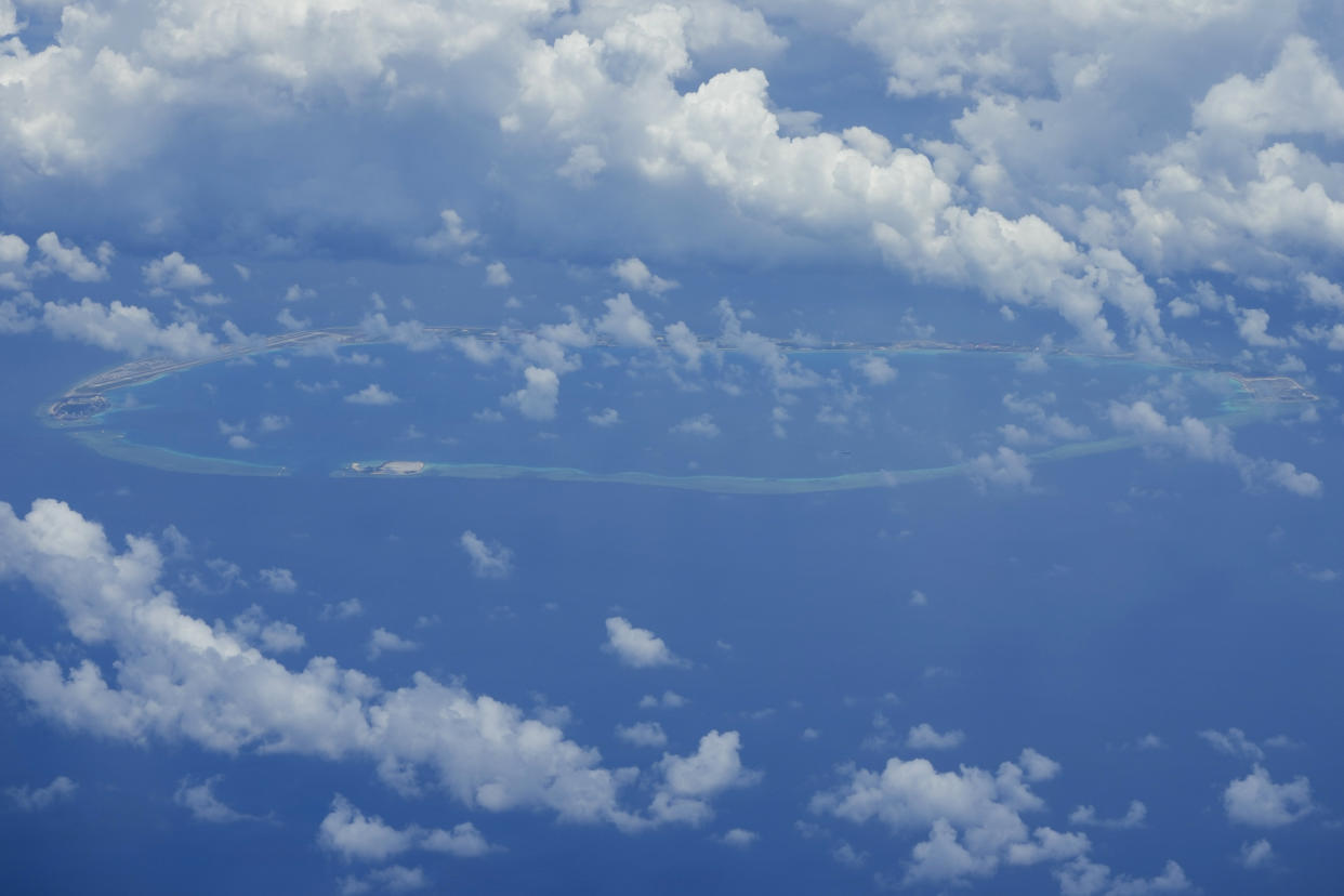 Chinese structures and buildings at the man-made island on Mischief Reef at the Spratlys group of islands in the South China Sea are seen on Sunday March 20, 2022. China has fully militarized at least three of several islands it built in the disputed South China Sea, arming them with anti-ship and anti-aircraft missile systems, laser and jamming equipment and fighter jets in an increasingly aggressive move that threatens all nations operating nearby, a top U.S. military commander said Sunday. (AP Photo/Aaron Favila)