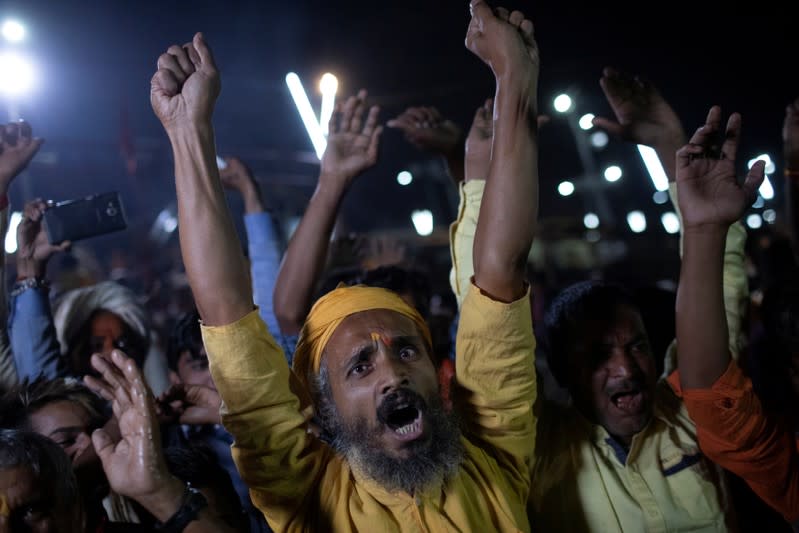 Hindu devotees shout slogans as they celebrate after Supreme Court's verdict on a disputed religious site, in Ayodhya