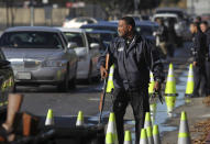 Police officers collect guns from people in their cars at a gun buyback held by the Los Angeles Police Department in Los Angeles, California, December 26, 2012 following the mass shooting at Sandy Hook Elementary School in Connecticut. The program normally occurs in May but Los Angeles mayor Antonio Villaraigosa accelerated the schedule in response to the December 14 shooting that left 20 children and six adults dead, along with the gunman, and caused a national outcry against gun violence. People can anonymously trade in their guns, no questions asked, for $200 grocery store gift cards for automatic weapons and $100 gift cards for shotguns, handguns and rifles. REUTERS/David McNew (UNITED STATES - Tags: CRIME LAW SOCIETY POLITICS)