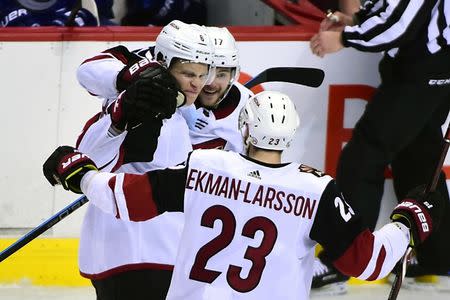 Feb 21, 2019; Vancouver, British Columbia, CAN; Arizona Coyotes defenseman Jakob Chychrun (6) celebrates with defenseman Oliver Ekman-Larsson (23) and forward Alex Galchenyuk (17) after scoring a goal against Vancouver Canucks goaltender Jacob Markstrom (not pictured) during the third period at Rogers Arena. Mandatory Credit: Anne-Marie Sorvin-USA TODAY Sports
