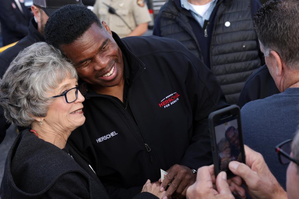 Georgia Republican senate candidate Herschel Walker greets supporters during a campaign rally on 4 December 2022 in Loganville, Georgia (Getty Images)
