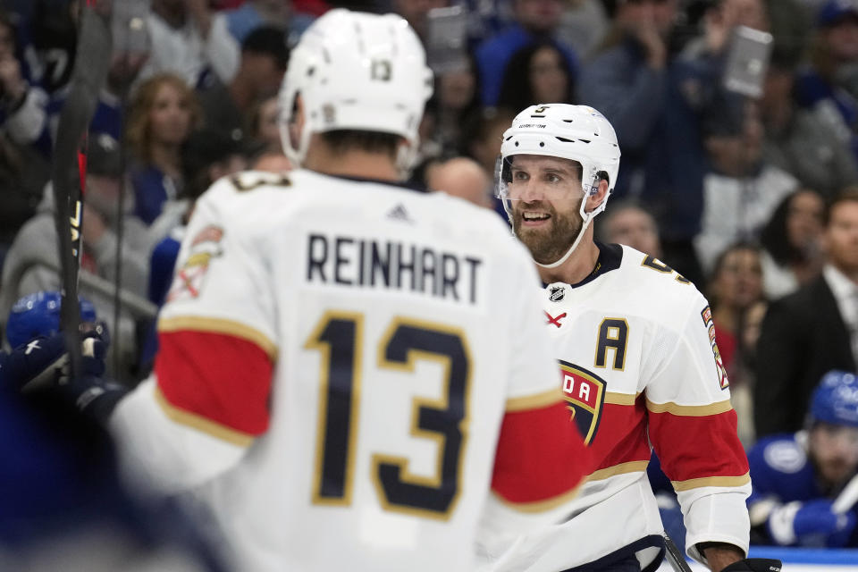 Florida Panthers defenseman Aaron Ekblad (5) celebrates with center Sam Reinhart (13) after scoring against the Tampa Bay Lightning during the first period of an NHL hockey game Wednesday, Dec. 27, 2023, in Tampa, Fla. (AP Photo/Chris O'Meara)