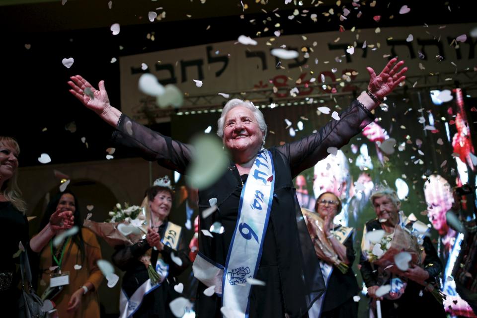 Rita Berkowitz, a Holocaust survivor and winner of a beauty contest for survivors of the Nazi genocide, waves on a stage, in the northern Israeli city of Haifa