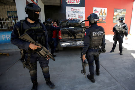 State police patrol check a driver and his truck ahead of the visit of Mexico's President Andres Manuel Lopez Obrador to Badiraguato, in the Mexican state of Sinaloa, Mexico February 15, 2019. REUTERS/Daniel Becerril