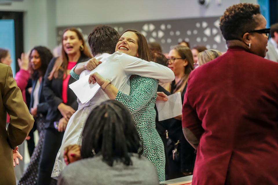 Michigan Rep. Lauren Pohutsky hugs Dr. Sarah Wallett, Planned Parenthood chief medical operating officer, before a news conference where Gov. Gretchen Whitmer signed the Reproductive Health Act with lawmakers and activists who worked to get the legislation passed at Schoolcraft College in Livonia, Mich., on Tuesday, Nov. 21, 2023. Both women were instrumental in getting the legislation passed and vow to keep working to get the rest of the bill passed that was excluded like mandatory 24-hour, and Medicaid coverage.