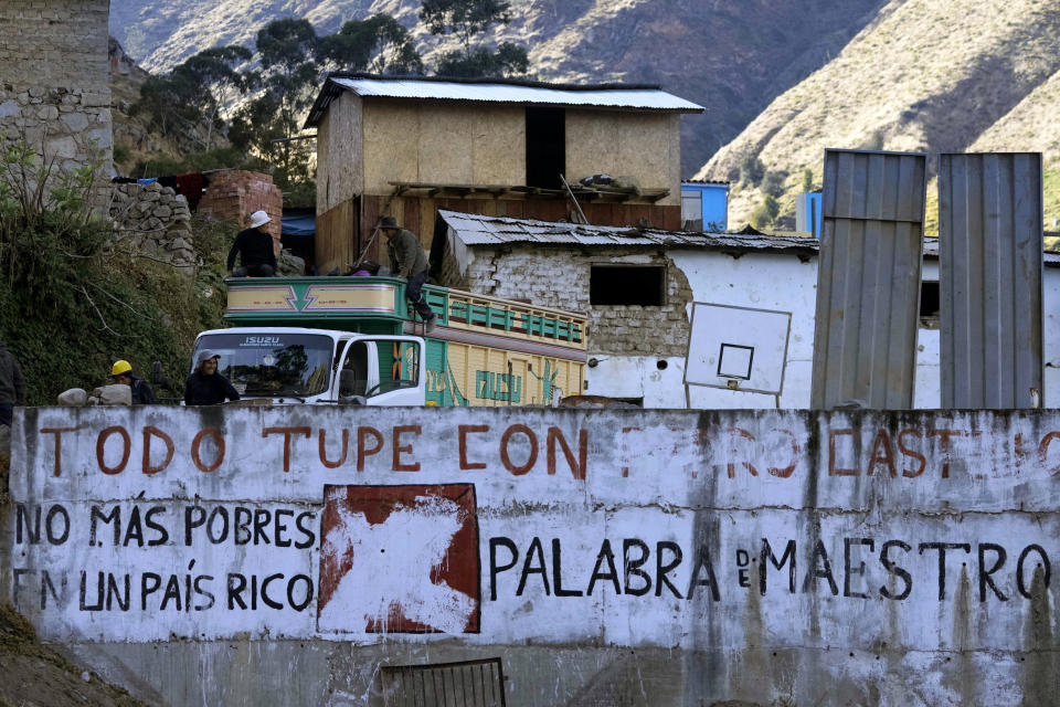 A wall is covered by the Spanish phrase: "No more poor people in a rich country," which was an election campaign slogan used by current President Pedro Castillo, in Tupe, Peru, Tuesday, July 19, 2022. Castillo won the presidency with that slogan, and promises of fighting corruption, raising taxes on mining profits, rewriting the constitution and ending alleged monopolies that affect the prices of domestic gas and medicines. (AP Photo/Martin Mejia)