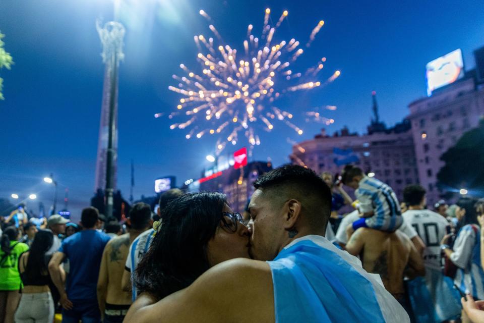 Fans of Argentina celebrate winning the Qatar 2022 World Cup against France at the Obelisk  in Buenos Aires, on December 18, 2022. (Photo by TOMAS CUESTA / AFP) (Photo by TOMAS CUESTA/AFP via Getty Images)