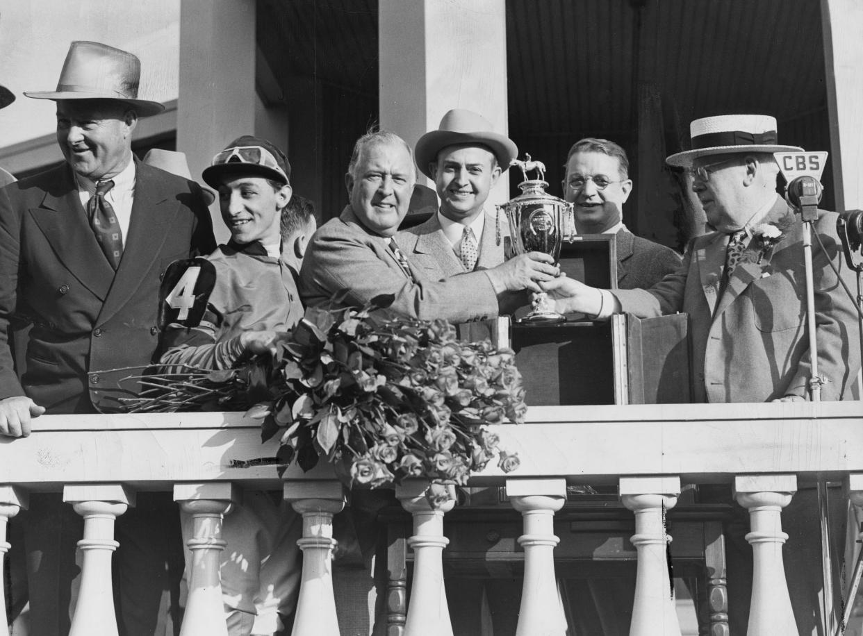 The winner's circle presentation for Whirlaway's victory in the Kentucky Derby on May 3, 1941, included (from left) trainer Ben Jones, jockey Eddie Arcaro, owner Warren Wright of Calumet Farm, Gov. Keen Johnson, Mayor Joseph Scholtz and Col. Matt Winn. Whirlaway went on to win the Triple Crown that year. Calumet Farm has more Kentucky Derby triumphs (eight) than any other owner.