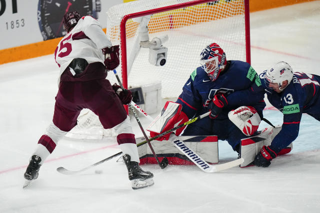 United States Cutter Gauthier (19) falls to the ice chasing the puck near  Latvia's Rudolfs Balcers (21) in their bronze medal match at the Ice Hockey  World Championship in Tampere, Finland, Sunday