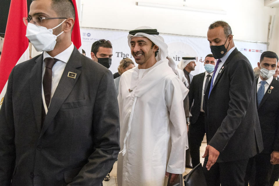 After meeting for the Negev Summit, United Arab Emirates' Foreign Minister Sheikh Abdullah bin Zayed Al Nahyan, center, leaves the room after posing for a group photograph Monday, March 28, 2022, in Sde Boker, Israel. (AP Photo/Jacquelyn Martin, Pool)