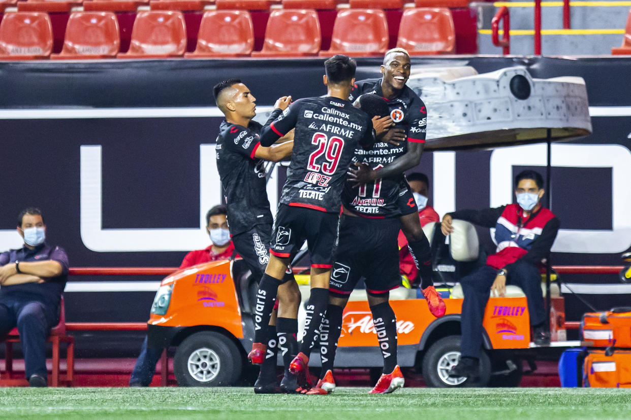 TIJUANA, MEXICO - SEPTEMBER 04: Players of Tijuana Christian Rivera, Ivan Lopez and Bryan Angulo celebrate with Fabian Castillo after he scored the second goal of his team during the 8th round match between Tijuana and Monterrey as part of the Torneo Guard1anes 2020 Liga MX at Caliente Stadium on September 4, 2020 in Tijuana, Mexico. (Photo by Francisco Vega/Getty Images)