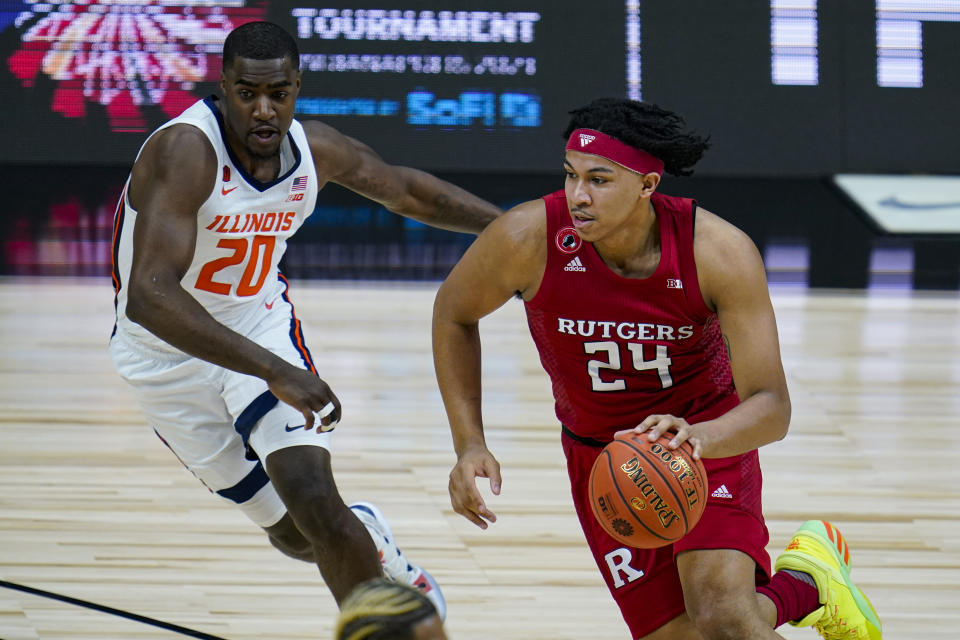 Rutgers guard Ron Harper Jr. (24) drives on Illinois guard Da'Monte Williams (20) in the Big Ten tournament. (AP Photo/Michael Conroy)