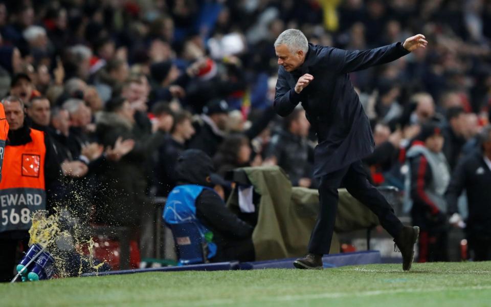 Mourinho celebrates a goal by hurling water bottles into the ground - Action Images via Reuters