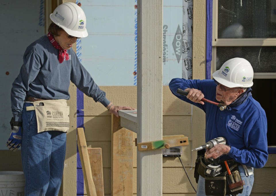 Former president Jimmy Carter and his wife, Rosalynn, work on building a home during Habitat for Humanity's Carter Work Project event in the Globeville Neighborhood in Denver, October 09, 2013.  / Credit: RJ Sangosti/The Denver Post via Getty Images