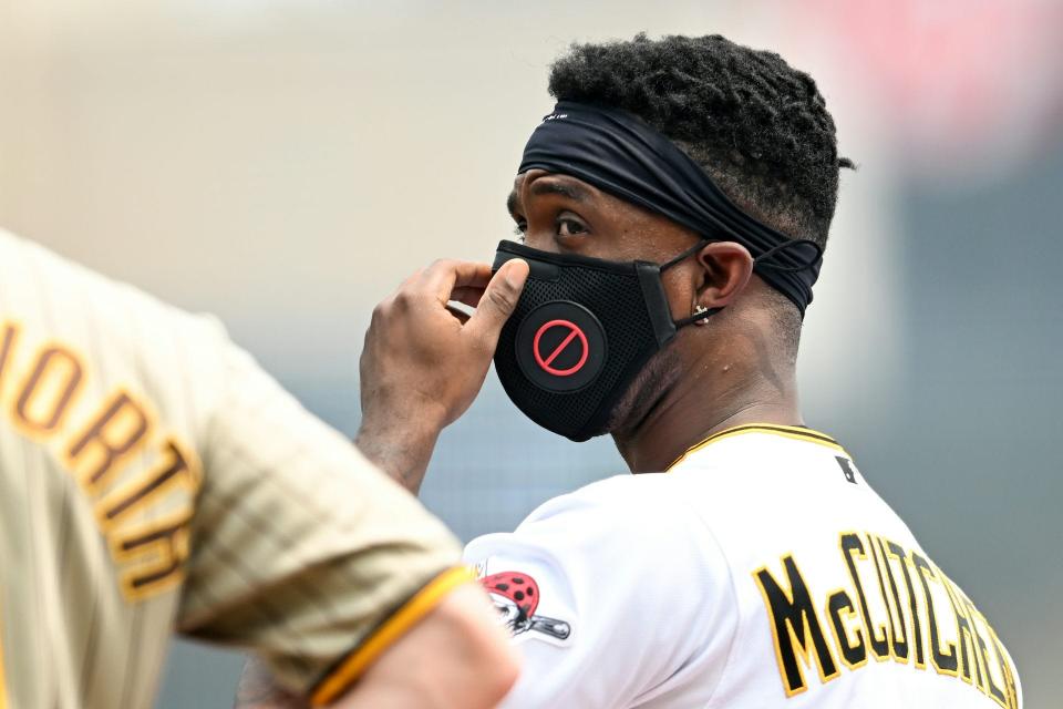 Pittsburgh Pirates center fielder Andrew McCutchen wore a face mask to protect against smoke in the air during a Pirates-Padres game on June 29, 2023, in Pittsburgh.