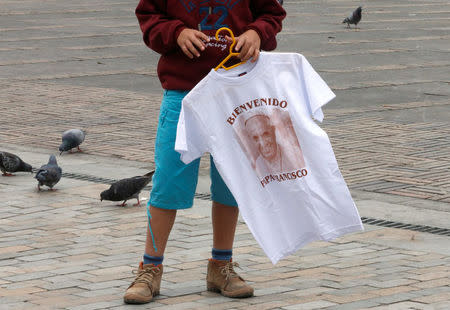 A person sells a shirt with an image of Pope Francis outside the Cathedral of Bogota in Bolivar Square, Colombia September 2, 2017. REUTERS/Henry Romero