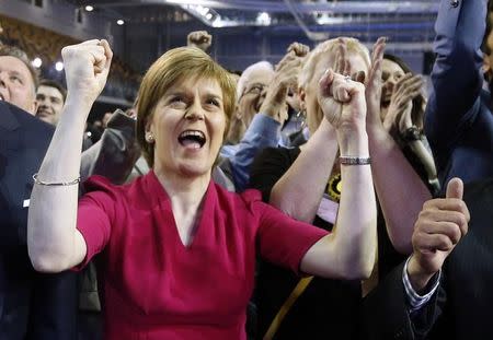 Nicola Sturgeon, leader of the Scottish National Party, reacts surrounded by candidates and supporters at a counting centre in Glasgow, Scotland, May 8, 2015. REUTERS/Russell Cheyne