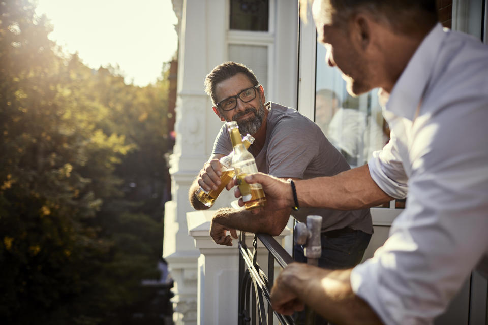 Two mature men sharing a beer together