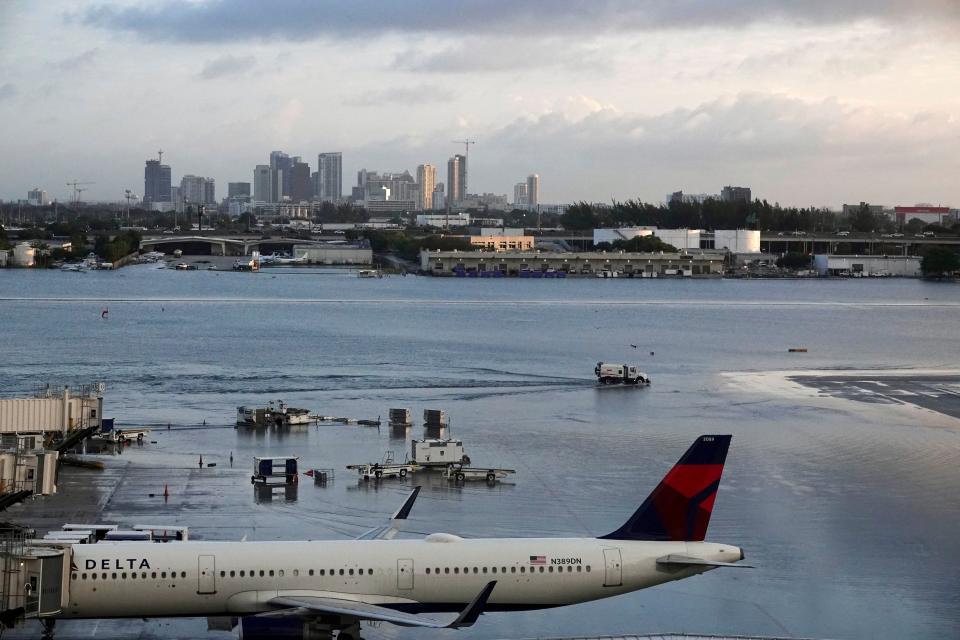 Airplanes sit on the runway due to flooding at Fort Lauderdale Hollywood airport Thursday, April 13, 2023 in Fort Lauderdale, Fla. Nearly a foot of rain fell in a matter of hours in Fort Lauderdale – causing widespread flooding, the closure of the city’s airport, all public schools and the suspension of high-speed commuter rail service. (Joe Cavaretta /South Florida Sun-Sentinel via AP)