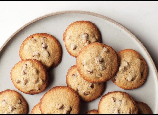 SERVINGS: MAKES 20   COOK: 20 MINUTES    <strong>INGREDIENTS  </strong>1 cup plus 2 tablespoons all-purpose flour  3/4 teaspoon kosher salt  1/2 teaspoon baking powder  3/4 cup (1 1/2 sticks) unsalted butter, room temperature  3/4 cup (packed) light brown sugar  1/4 cup sugar  1 large egg, room temperature  1/2 teaspoon vanilla extract  1 cup semisweet or bittersweet chocolate chips    <strong>PREPARATION  </strong>Arrange racks in upper and lower thirds of oven; preheat to 425°. Line 2 baking sheets with parchment paper. Whisk flour, salt, and baking powder in a small bowl. Using an electric mixer on medium-high speed, beat butter and both sugars in a large bowl until well combined, 2–3 minutes. Add egg and vanilla; beat on medium-high speed until mixture is light and fluffy, 2–3 minutes. Add dry ingredients, reduce speed to low, and mix just to blend. Fold in chocolate chips. Spoon heaping tablespoonfuls of dough onto prepared baking sheets, spacing 1 1/2" apart. Bake, rotating pans halfway through, until edges are golden brown, 6–8 minutes. Transfer to wire racks and let cool. DO AHEAD: Can be made 1 day ahead. Store airtight at room temperature, or freeze cookies for up to 2 months.  <em>  Photo by Tarra Donne</em>