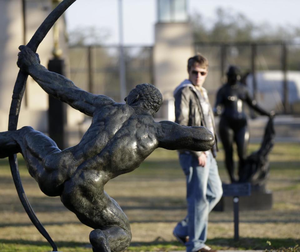 People walk through the Sydney Walda Besthoff Sculpture Garden in City Park in New Orleans, Tuesday, Jan. 15, 2013. The New Orleans Museum of Art is located in the park, and while there's a fee to enter the museum, just beyond the museum are dozens of art objects you can see for free in the Sydney and Walda Besthoff Sculpture Garden. The sculptures, valued at more than $25 million, can be viewed in a relaxing setting that includes meandering footpaths, pedestrian bridges and reflecting lagoons. (AP Photo/Gerald Herbert)