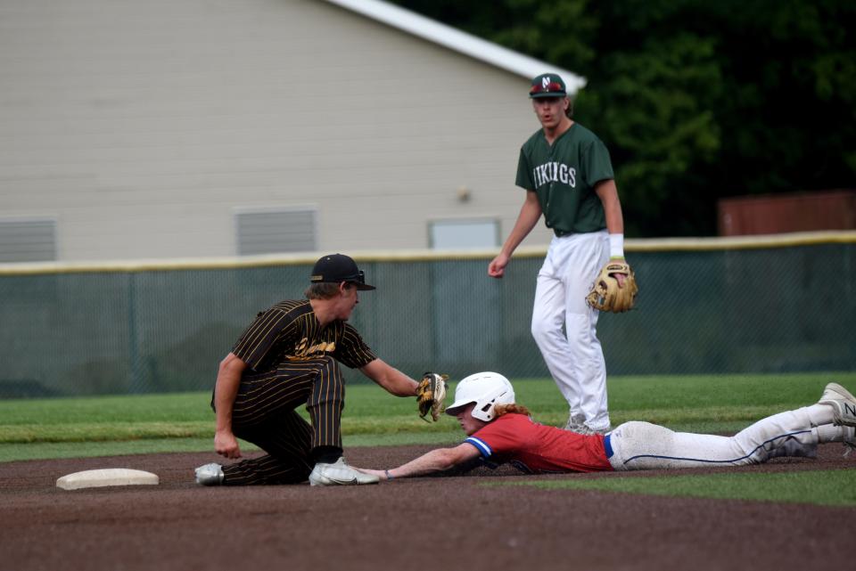 Watkins Memorial senior Cullen McFarland tries to tag out Highland's Zach Pinkerton on a steal attempt, as Licking County took on Knox County on Monday in the Tom Craze Memorial All-Star Game at Mount Vernon Nazarene.