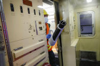 A contractor cleans a subway car at the 96th Street station to control the spread of COVID-19, Thursday, July 2, 2020, in New York. Mass transit systems around the world have taken unprecedented — and expensive — steps to curb the spread of the coronavirus, including shutting down New York subways overnight and testing powerful ultraviolet lamps to disinfect seats, poles and floors. (AP Photo/John Minchillo)