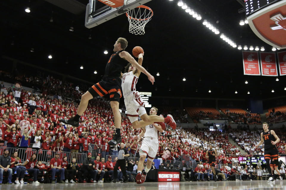 Washington State forward CJ Elleby (2) shoots while pressured by Oregon State guard Zach Reichle (11) during the second half of an NCAA college basketball game in Pullman, Wash., Saturday, Jan. 18, 2020. Washington State won 89-76. (AP Photo/Young Kwak)