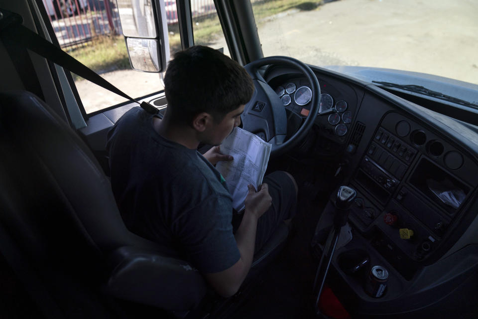 Student driver Edgar Lopez, 23, prepares for a practice driving session at California Truck Driving Academy in Inglewood, Calif., Monday, Nov. 15, 2021. Amid a shortage of commercial truck drivers across the U.S., a Southern California truck driving school sees an unprecedented increase in enrollment numbers. The increase is big enough that the school is starting an evening class to meet the demand, according to Tina Singh, owner and academy director of California Truck Driving Academy. "I think that's only going to continue because there's a lot of job opportunities. We have over 100 active jobs on our job board right now," said Singh. The companies that normally would not hire drivers straight out of school are "100 percent" willing to hire them due to shortage issues, the director added. (AP Photo/Jae C. Hong)